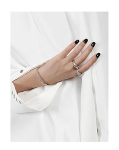 Detail of minimalist silver vine twisted bangle and matching rings on a female model