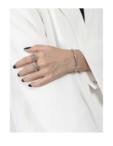 Detail of twisted vine S925 sterling silver ring set and bracelet on model's hand
