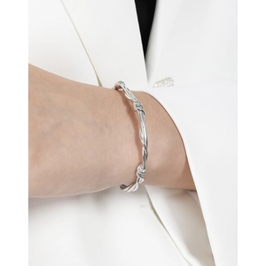 Minimalist S925 sterling silver vine twisted cuff bracelet worn with a white blazer