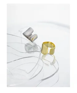 Minimalist wide open rings in gold and silver finish on clear acrylic base