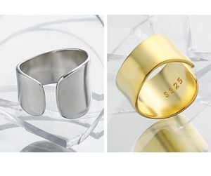 Detail view of S925 sterling silver stamp on minimalist gold and silver wide open rings