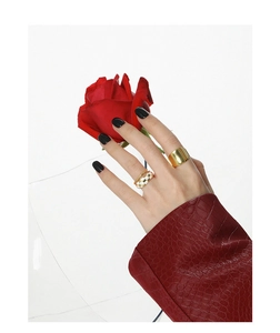 Detailed shot of a gold textured ring set with checkerboard pattern on a model hand