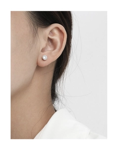 Close-up of a model wearing a minimalist S925 silver stud earring with bezel-set zircon