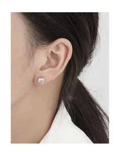 Close-up of minimalist bezel-set round zircon stud earring in S925 sterling silver