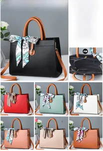 Close-up of leather handbag dimensions 30x13x22cm with decorative scarf detail