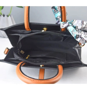Internal structure of bicolor handbag with multiple compartments and printed silk scarf