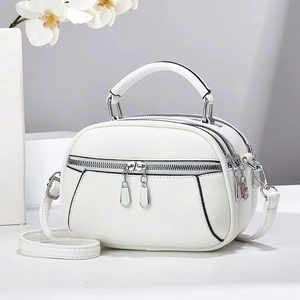 White mini round crossbody handbag with three zippers and textured leather for women