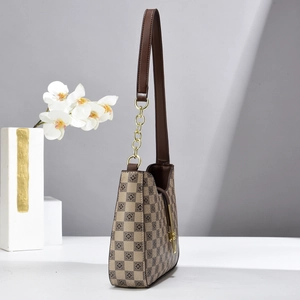 Brown checkered hobo shoulder bag with floral geometric pattern and gold chain link strap