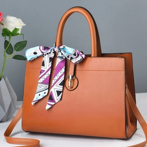 Minimalist brown leather tote bag with silk scarf and gold lock, crossbody style