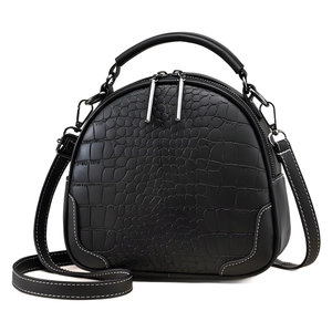 Classic black crocodile pattern handbag with crossbody strap and silver zipper closure