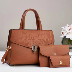 Three-piece camel leather bag set including tote and clutch with crocodile texture detail
