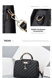 Detail of black quilted leather handbag showing golden deer pendant and hardware