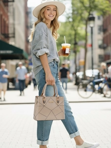 Close-up of khaki handbag with geometric stitching and elegant gold hardware