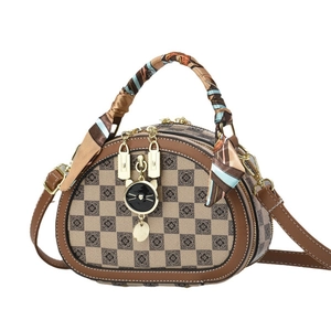 Sac à main ovale à damier marron et beige avec poignée foulard et pendentif chat doré