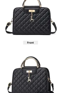 Detail view of black quilted handbag with golden deer charm and metal handle