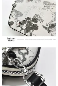 Detail der silbernen Bodenfüße und Metallhaken an der Tintentextur-Handtasche