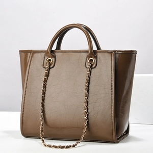 Brown glossy leather tote bag with chain strap and top handles for women commute