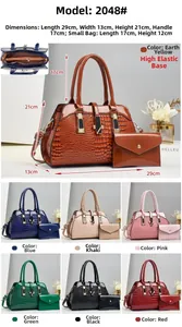 Detail of crocodile pattern handbag set with golden hardware and matching envelope pouch