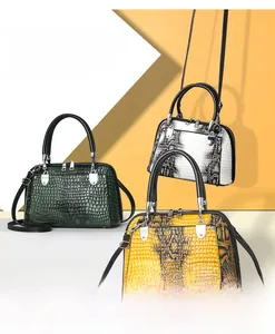 Three shell-shaped handbags in green crocodile, black-white snake, and yellow snake textures