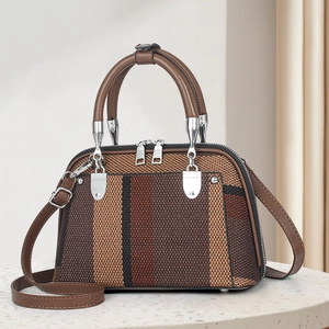 Chic striped patchwork shell handbag with woven texture and silver hardware accents