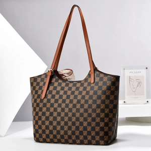 Macro shot of checkered tote bag texture featuring brown leather straps and silk scarf
