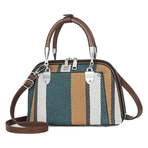 Chic tricolor striped woven handbag with adjustable leather shoulder strap on white backdrop