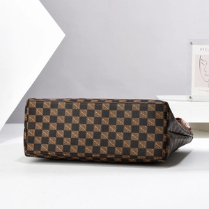 Macro view showing the sturdy bottom and checkered pattern of the leather tote bag