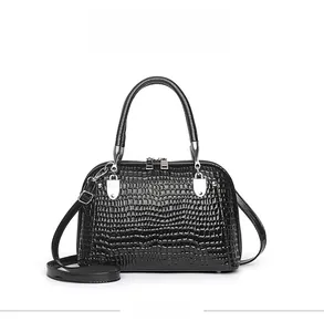 Front view of black faux leather shell bag featuring crocodile texture and silver hardware
