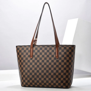 Checkered tote bag in brown and black with leather handles and decorative silk scarf