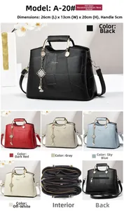 Detail view of a faux leather geometric patchwork handbag with tassel and triple interior