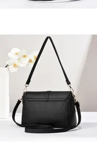 Detailed side and back view of elegant black pebbled leather crossbody handbag