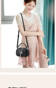Close-up of quilted black crossbody bag with silver chain tassel and cute bear charm