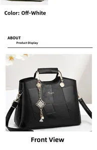 Detailed view of the black geometric handbag featuring a golden pearl charm and Feiyan logo