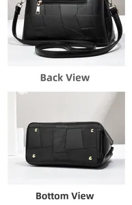 Detail view of the black leather handbag back zipper pocket and golden protective metal feet