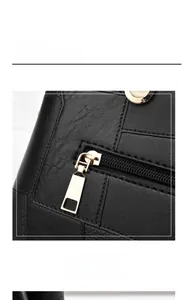 Detail of black pebbled leather handbag featuring a back zipper pocket and gold hardware