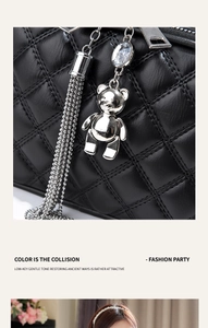 Detail of black quilted leather mini bag with silver bear charm and gemstone tassel