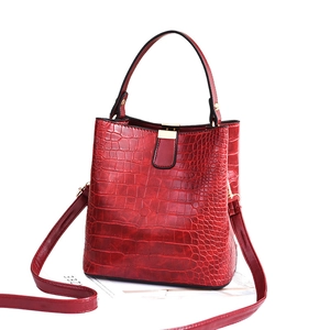 Chic red crocodile texture bucket bag with gold hardware and versatile straps