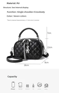 Detailed size view of black quilted crossbody bag with tassel and bear pendant