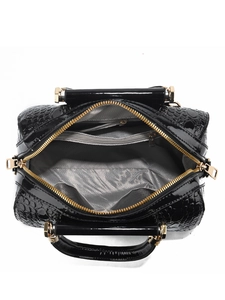 Detail view of the bag's interior with grey lining and double gold zipper pockets