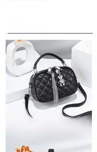 Front view of coffee quilted crossbody bag with metal tassel and bear charm