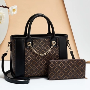 Detail view of brown monogram tote bag with matching long wallet and gold chain strap