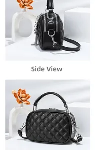 Side view of black quilted crossbody bag with silver zippers and metal chain pendant