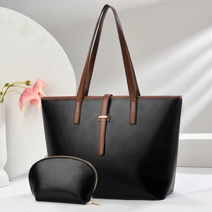 Classic black and caramel tote bag set with a small matching purse on a clean background