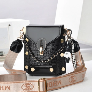 Fashionable black crocodile embossed mini crossbody bag with wide strap and panda charm