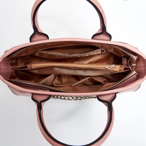 Spacious pink tote bag interior with multiple compartments and gold chain details