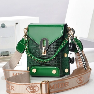 Retro green mini bag with crocodile texture and wide lettered shoulder strap