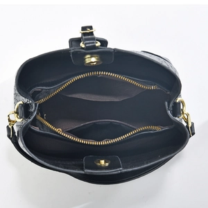 Detail view of the black croc-embossed bucket bag showing three internal compartments