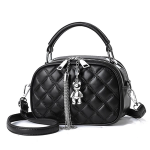 Black quilted crossbody bag for women with silver bear charm and tassel detail