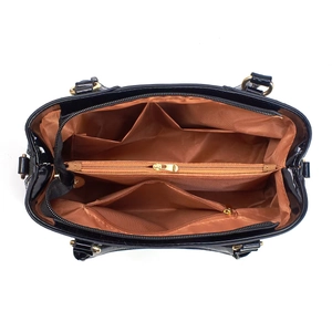 Vue intérieure du sac à main en cuir verni noir montrant les compartiments et la doublure