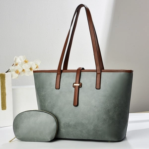 Detail of grey-green tote bag set with matching coin purse on minimalist display stand
